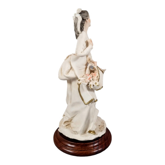 A. Belcari Capodimonte figurine of a young woman holding a flower basket