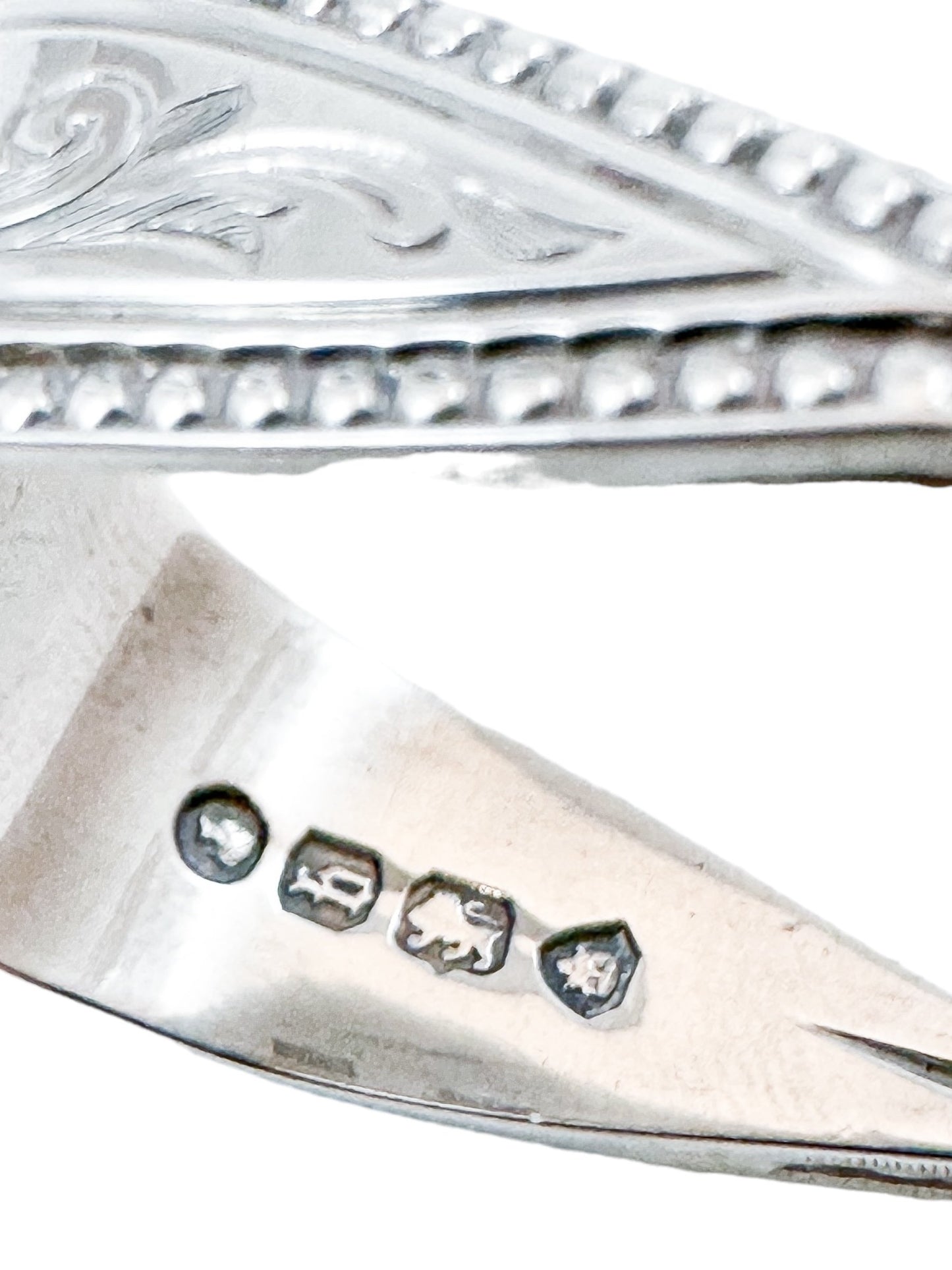 Early Victorian sterling silver sugar tongs with twisted arms and foliate engraving