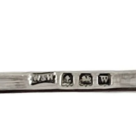 George V round sterling silver 4 slot 5 bar toast rack raised on bun feet, Walker & Hall