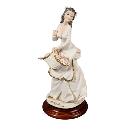 A. Belcari Capodimonte figurine of a young woman holding a flower basket
