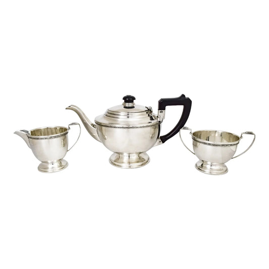 Three piece Art Deco sterling tea set with bow garlands and geometric handles