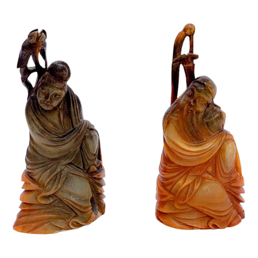 Antique Chinese pair of Immortals / Deities carved in buffalo horn, holding a staff and a lotus flower