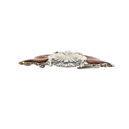 Quirky winged devil face brooch in sterling silver and orange enamel