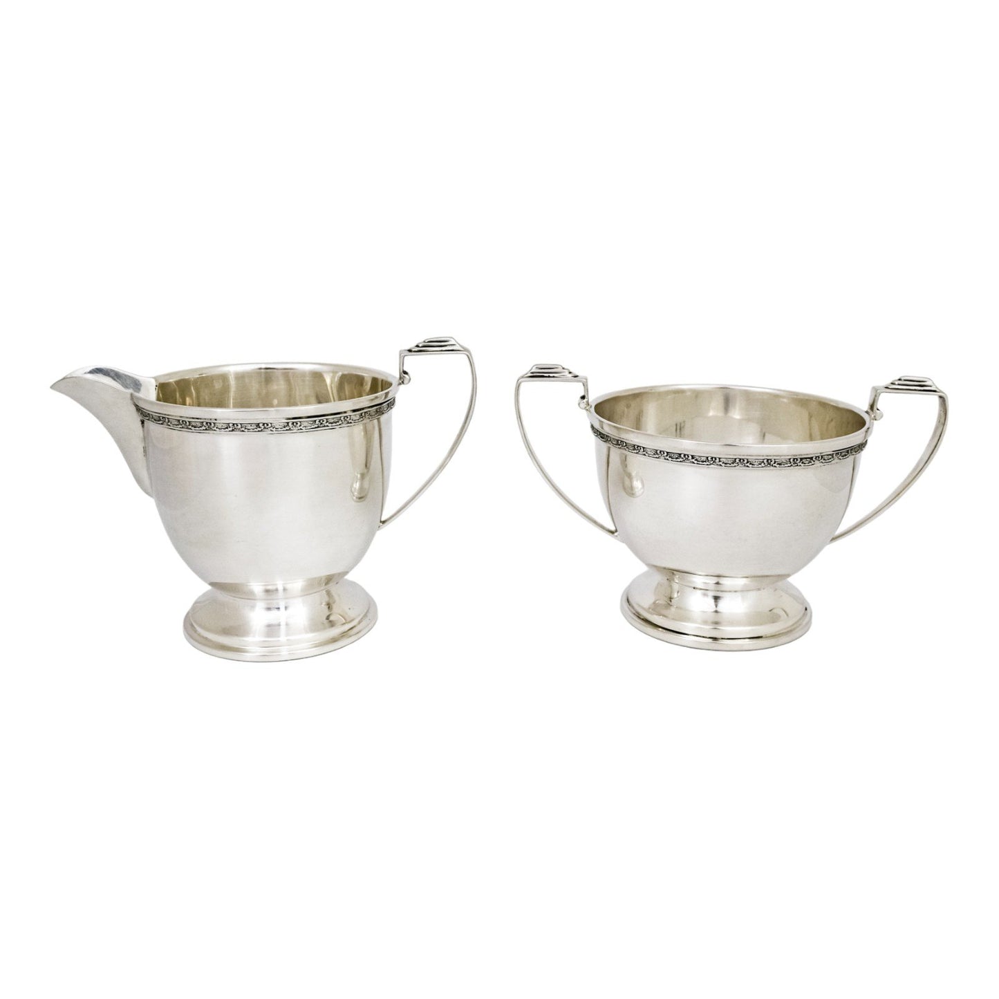 Three piece Art Deco sterling tea set with bow garlands and geometric handles
