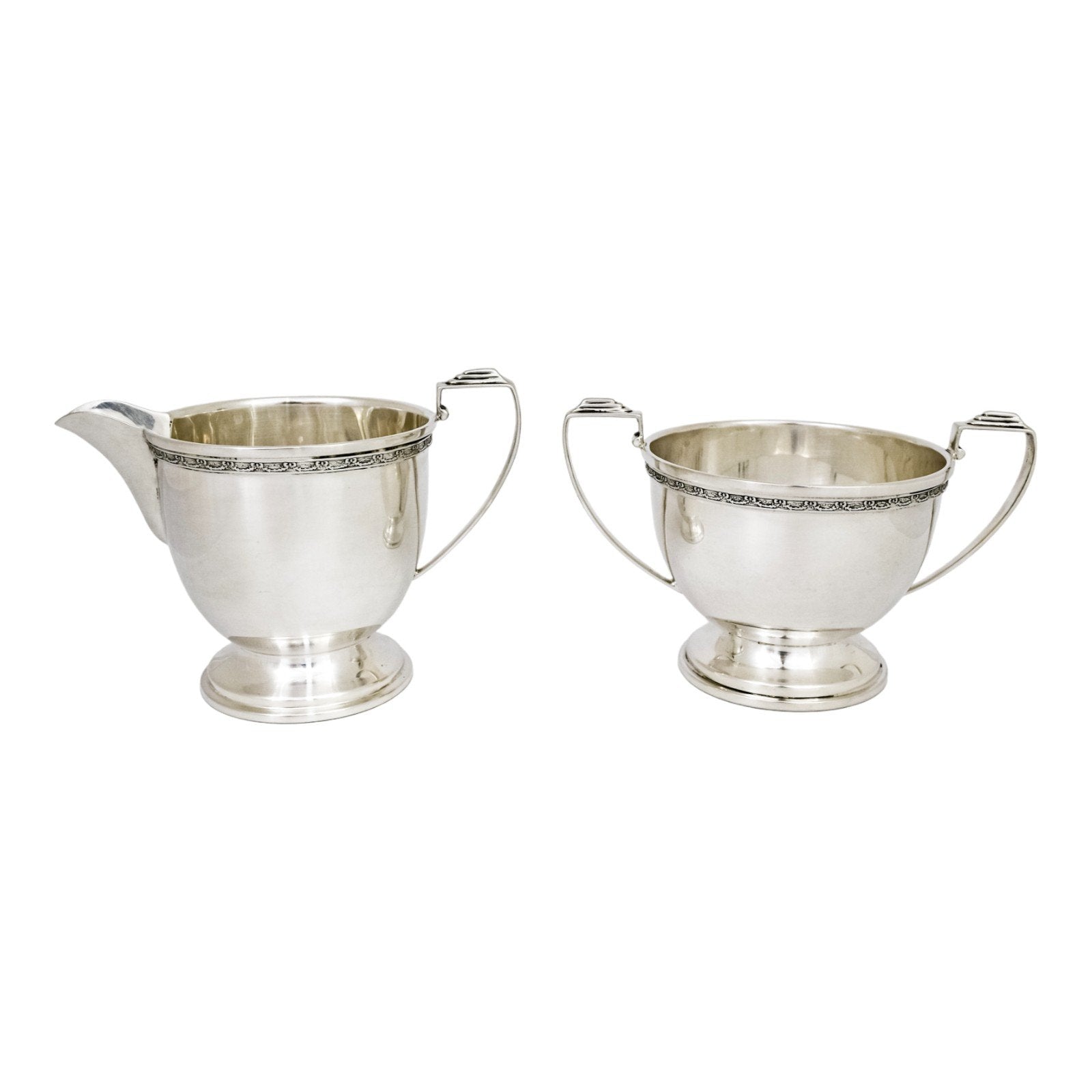Three piece Art Deco sterling tea set with bow garlands and geometric handles