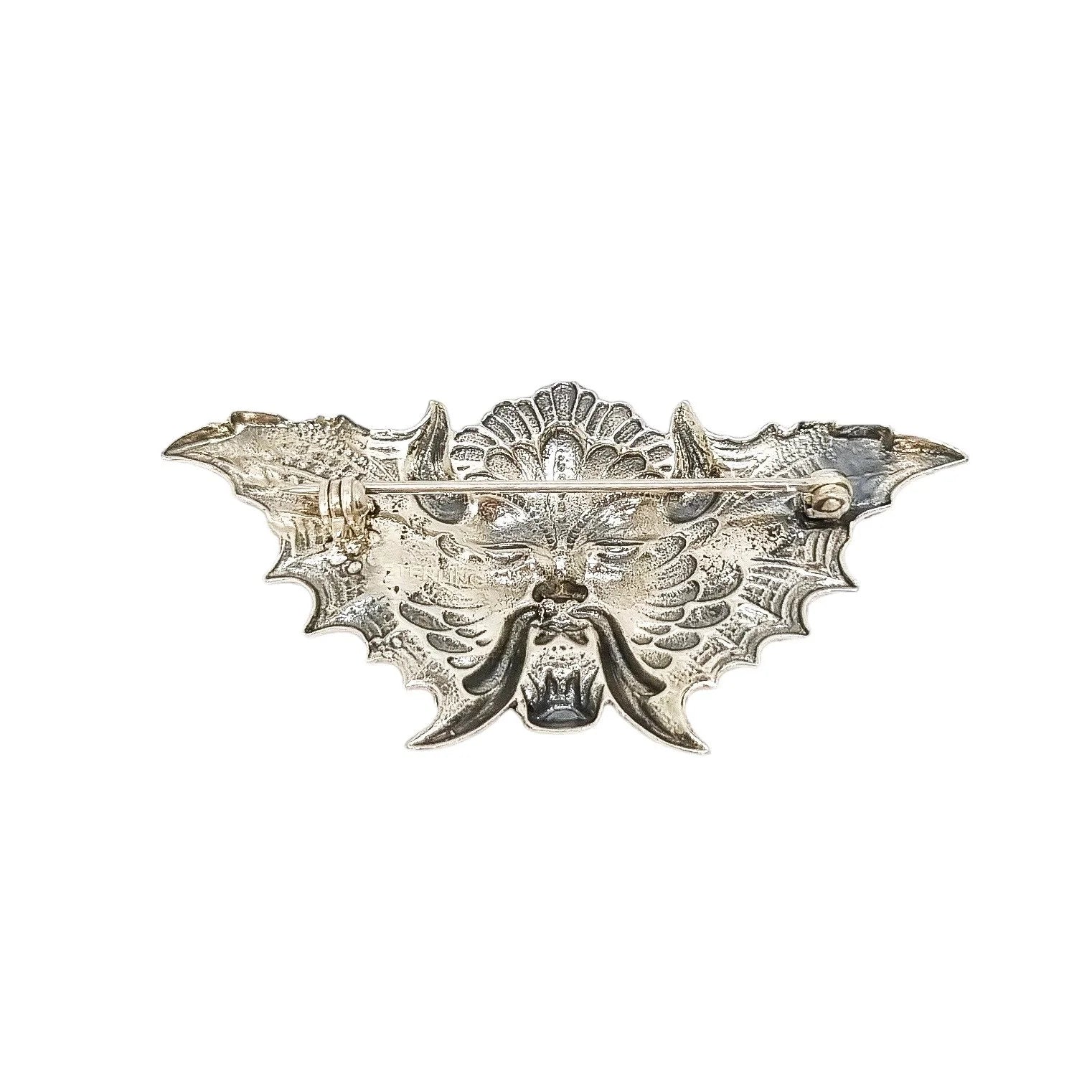 Quirky winged devil face brooch in sterling silver and orange enamel