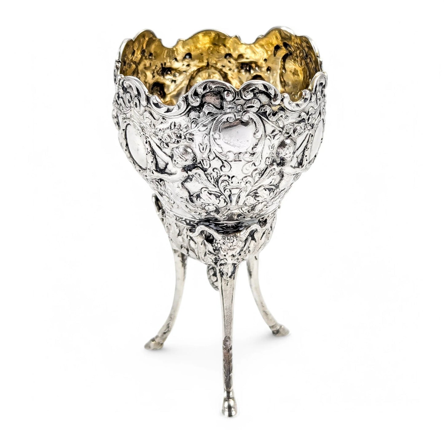Hanau sterling silver tripod cup with repoussé putti, floral garlands, and ram’s head feet, Baroque Revival, c. 1880s