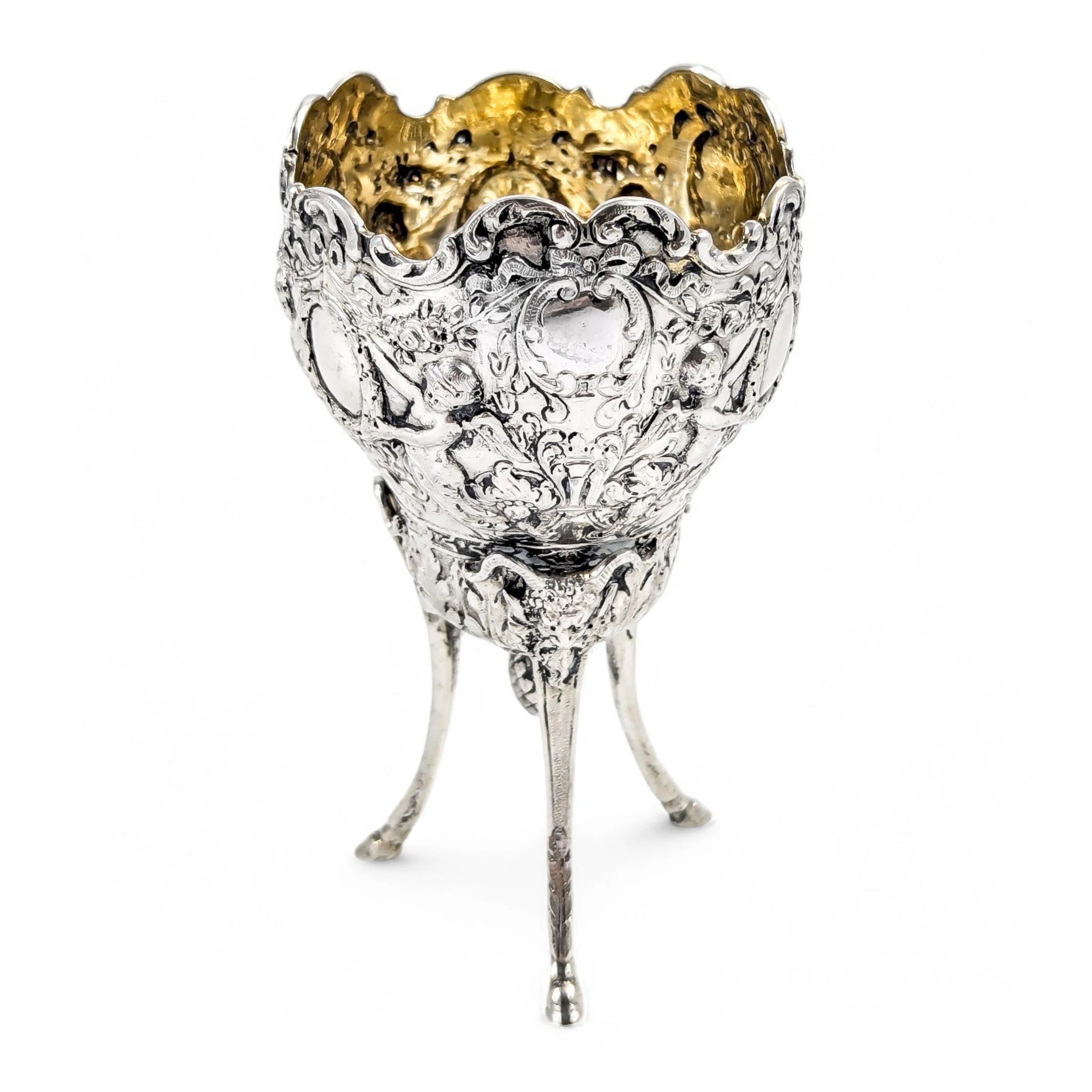 Hanau sterling silver tripod cup with repoussé putti, floral garlands, and ram’s head feet, Baroque Revival, c. 1880s