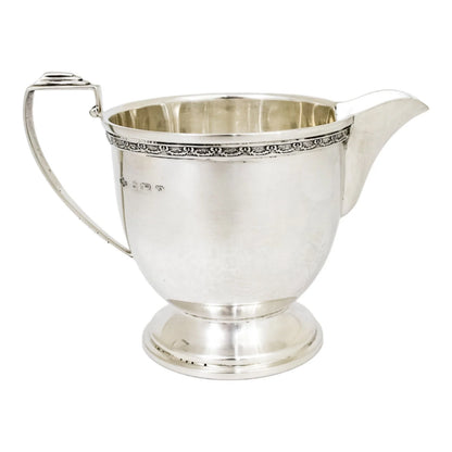 Three piece Art Deco sterling tea set with bow garlands and geometric handles