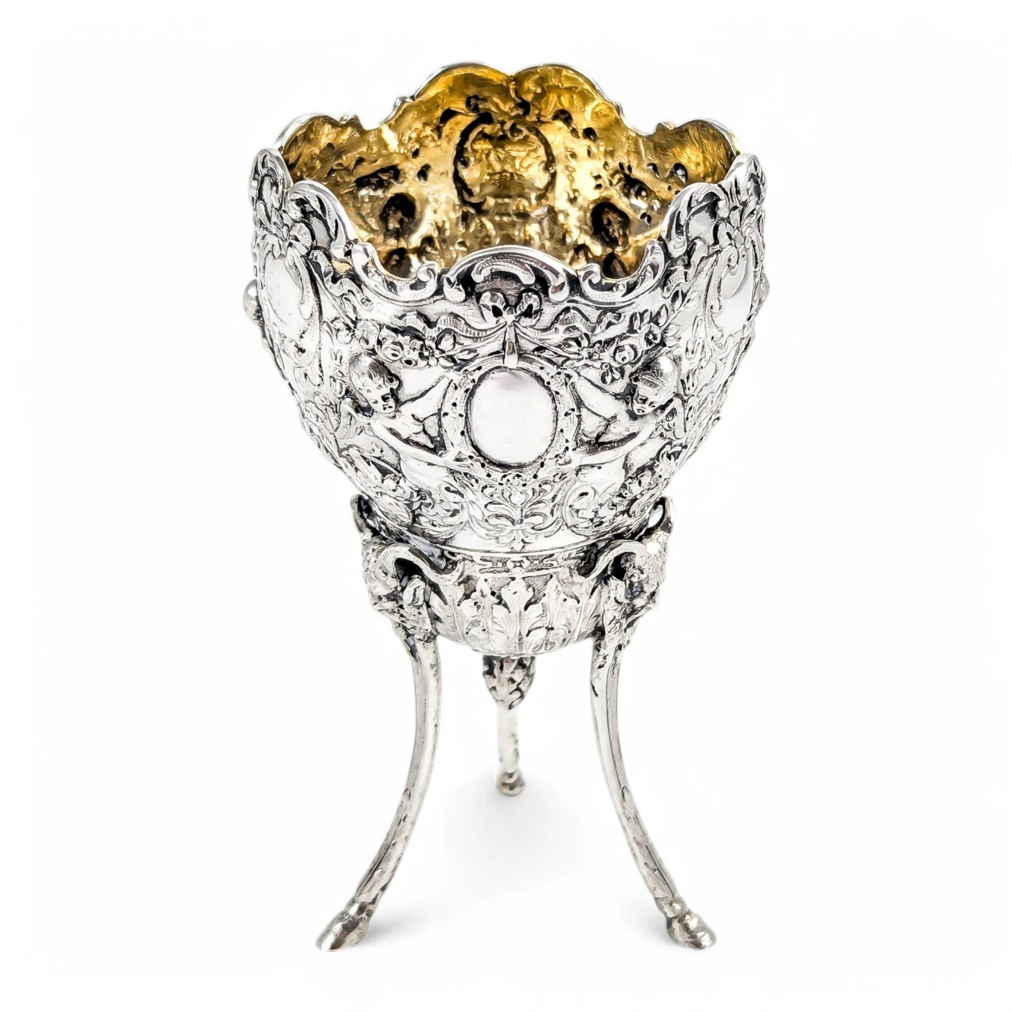 Hanau sterling silver tripod cup with repoussé putti, floral garlands, and ram’s head feet, Baroque Revival, c. 1880s