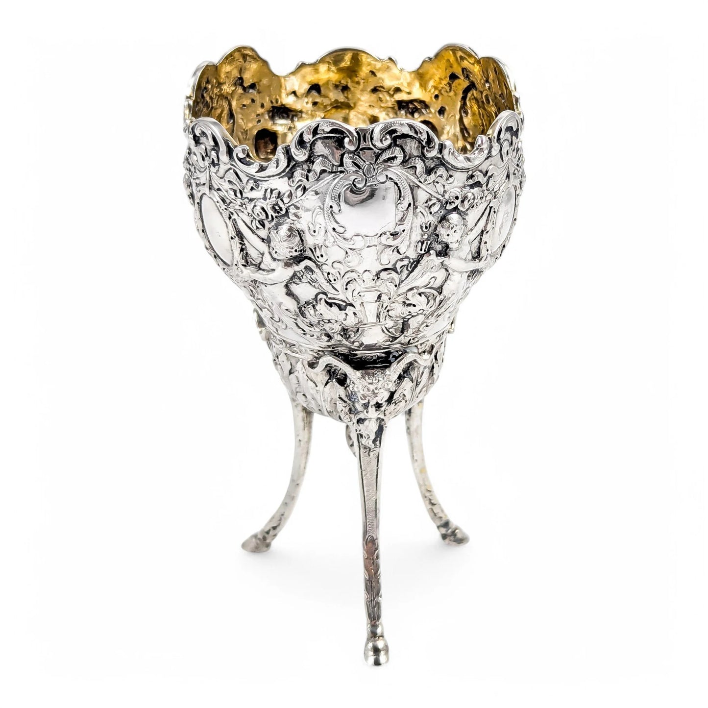Hanau sterling silver tripod cup with repoussé putti, floral garlands, and ram’s head feet, Baroque Revival, c. 1880s