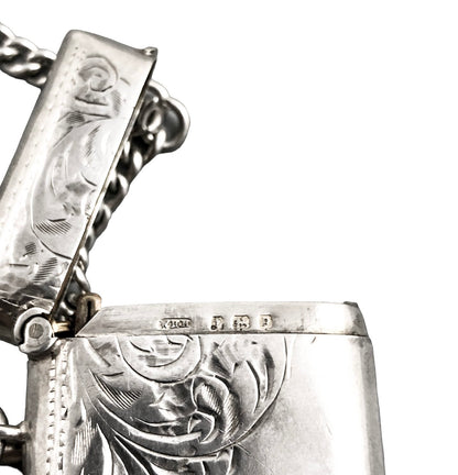WWI sterling silver vesta case engraved with scrolls, on a Victorian watch curb Albert chain