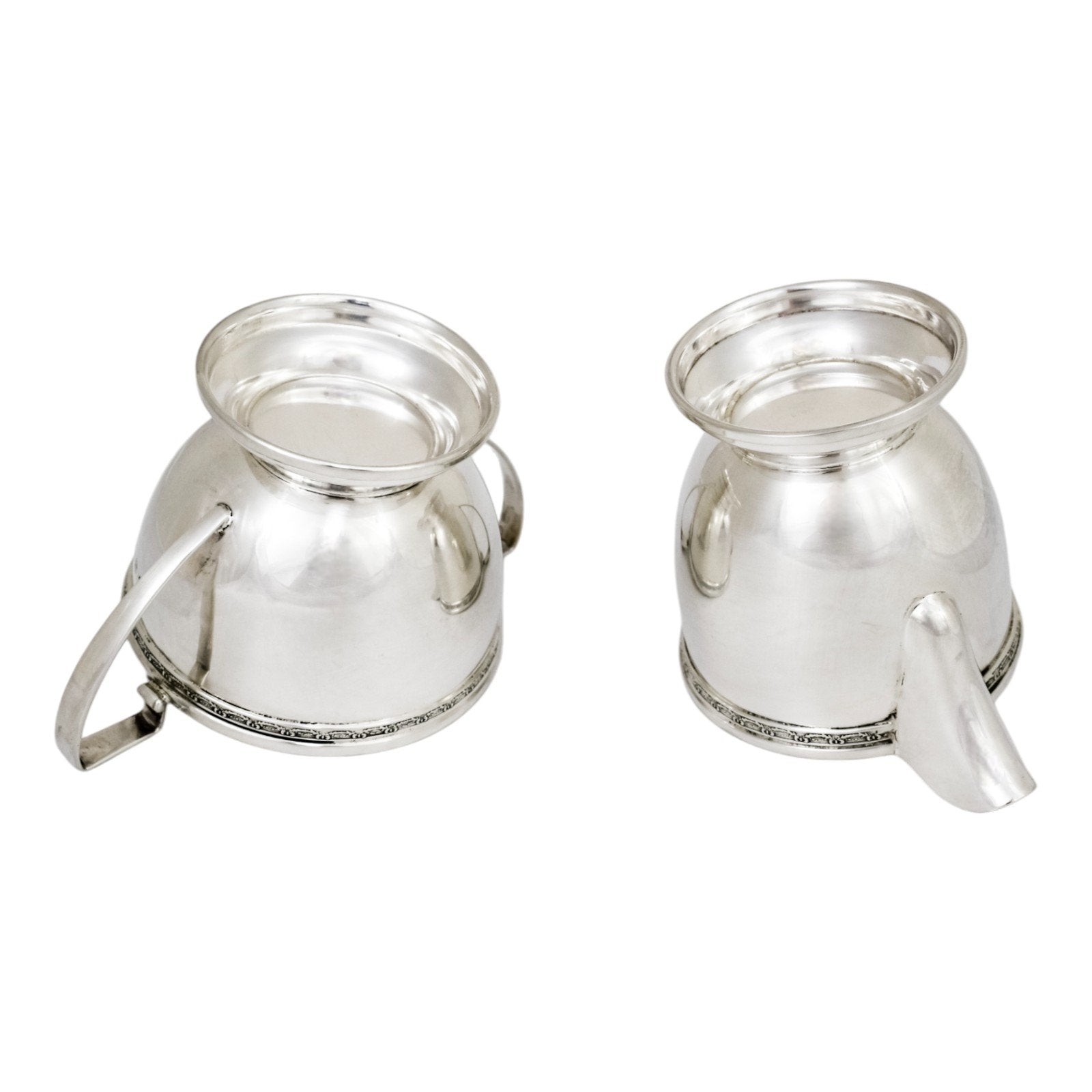 Three piece Art Deco sterling tea set with bow garlands and geometric handles