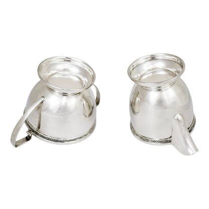 Three piece Art Deco sterling tea set with bow garlands and geometric handles