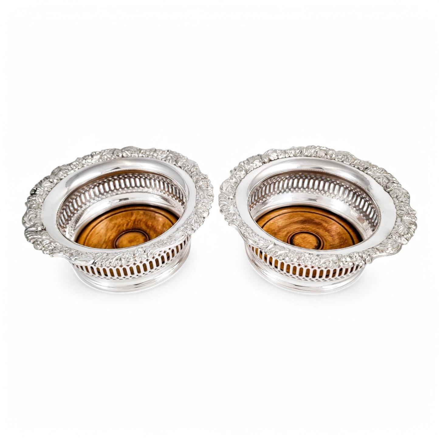 Antique silver plated magnum bottle coasters with Rococo foliate borders and mahogany bases, c. 1880s