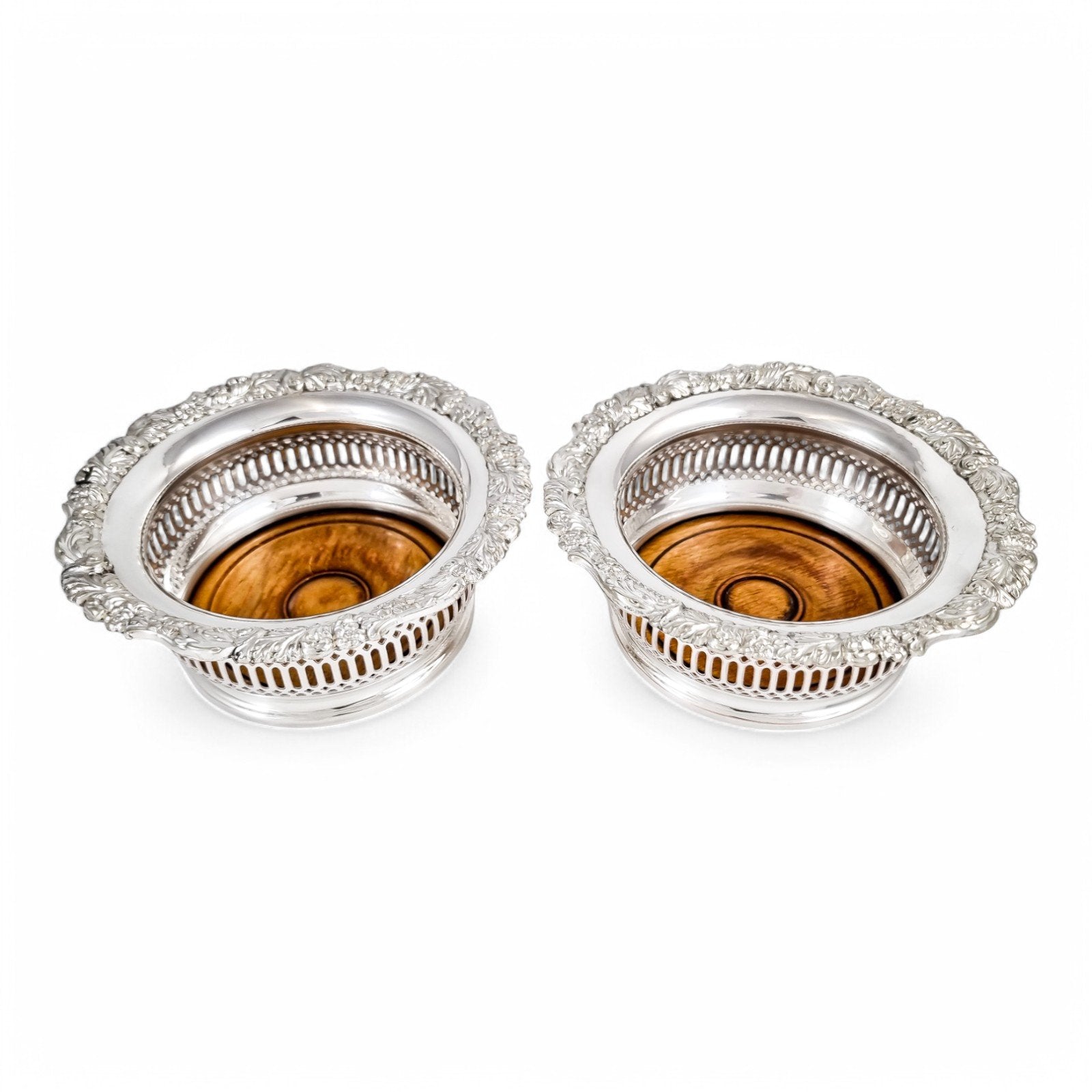 Antique silver plated magnum bottle coasters with Rococo foliate borders and mahogany bases, c. 1880s
