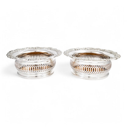 Antique silver plated magnum bottle coasters with Rococo foliate borders and mahogany bases, c. 1880s