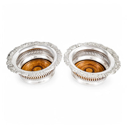 Antique silver plated magnum bottle coasters with Rococo foliate borders and mahogany bases, c. 1880s