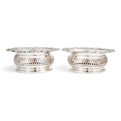 Antique silver plated magnum bottle coasters with Rococo foliate borders and mahogany bases, c. 1880s