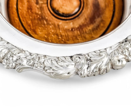 Antique silver plated magnum bottle coasters with Rococo foliate borders and mahogany bases, c. 1880s