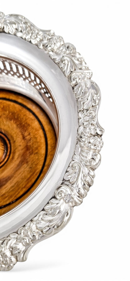 Antique silver plated magnum bottle coasters with Rococo foliate borders and mahogany bases, c. 1880s