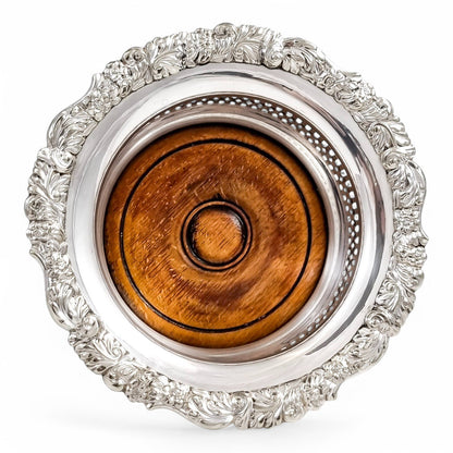 Antique silver plated magnum bottle coasters with Rococo foliate borders and mahogany bases, c. 1880s