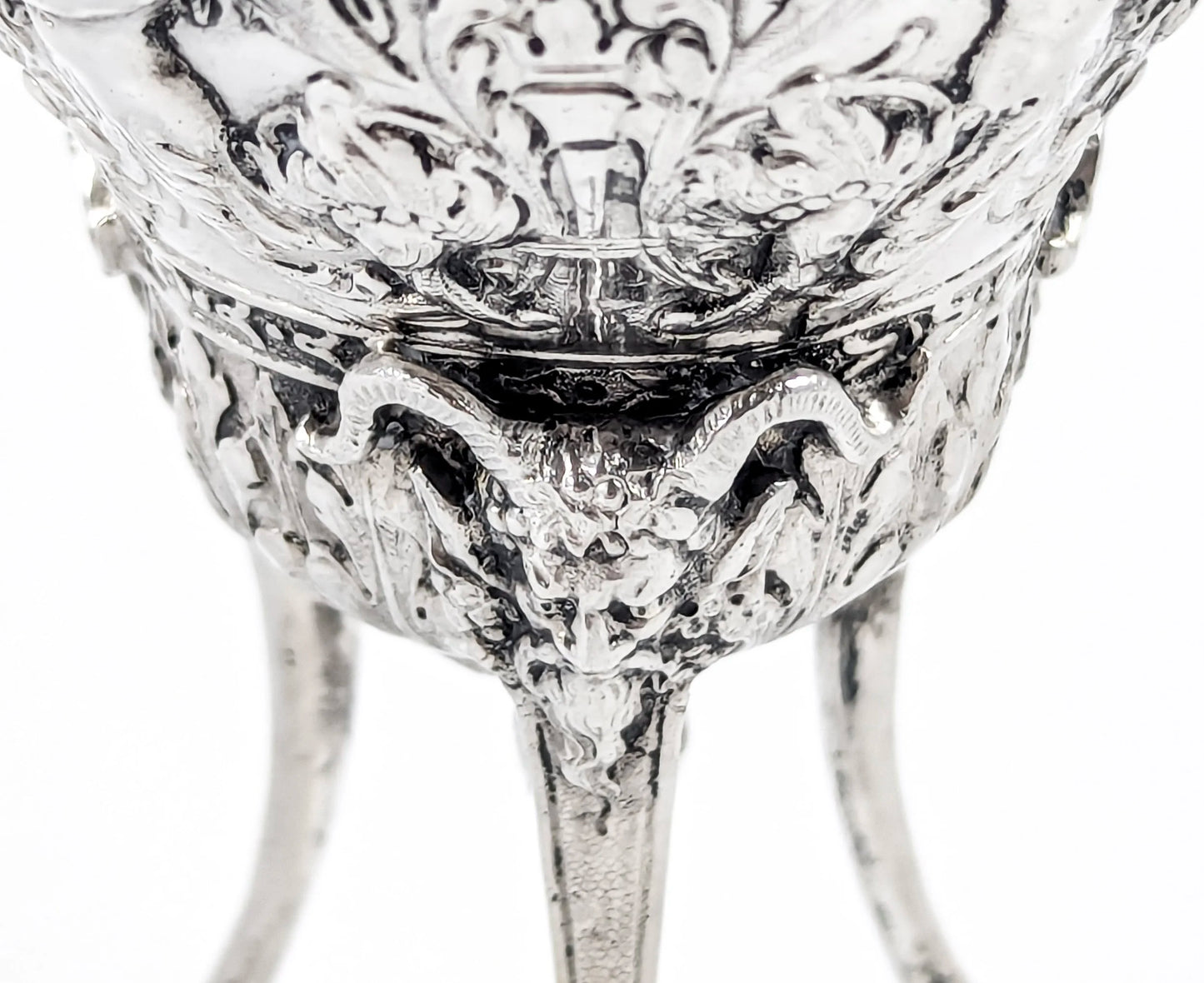 Hanau sterling silver tripod cup with repoussé putti, floral garlands, and ram’s head feet, Baroque Revival, c. 1880s