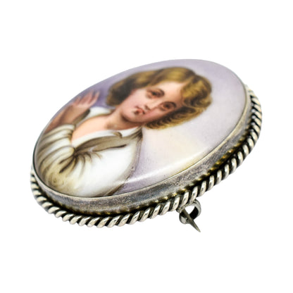 Victorian hand-painted porcelain portrait of a boy brooch in twisted rope silver frame