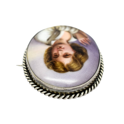 Victorian hand-painted porcelain portrait of a boy brooch in twisted rope silver frame