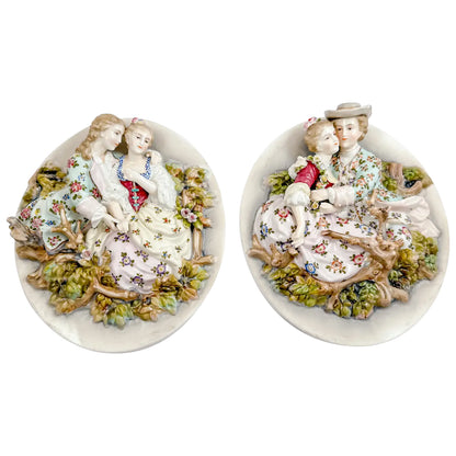 Pair early 19th Century porcelain Meissen style continental wall plaques, romantic scenes with lovers