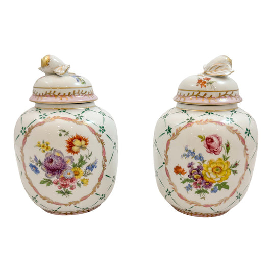 Pair of Royal Europe porcelain ginger jars with moulded lids and hand-painted with flowers