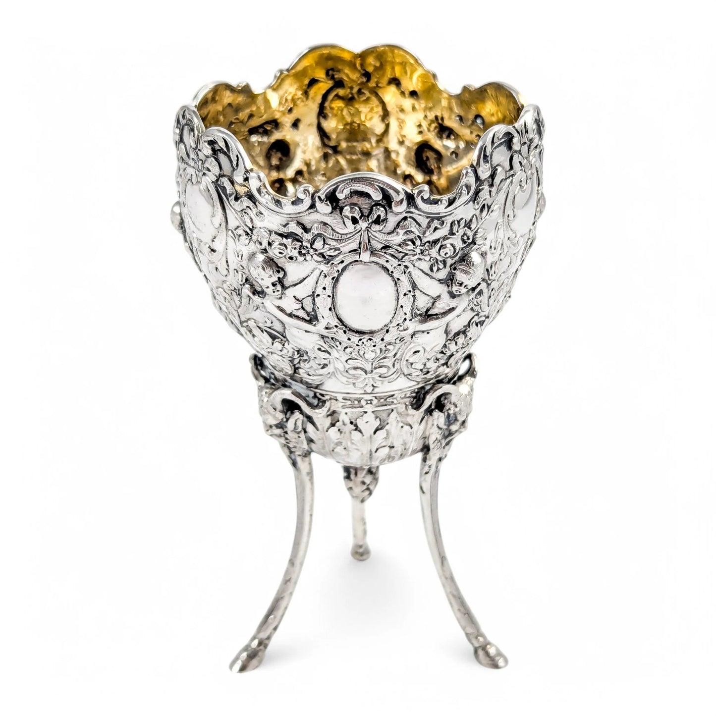 Hanau sterling silver tripod cup with repoussé putti, floral garlands, and ram’s head feet, Baroque Revival, c. 1880s