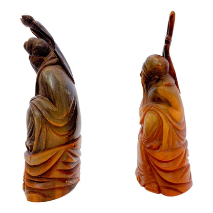 Antique Chinese pair of Immortals / Deities carved in buffalo horn, holding a staff and a lotus flower