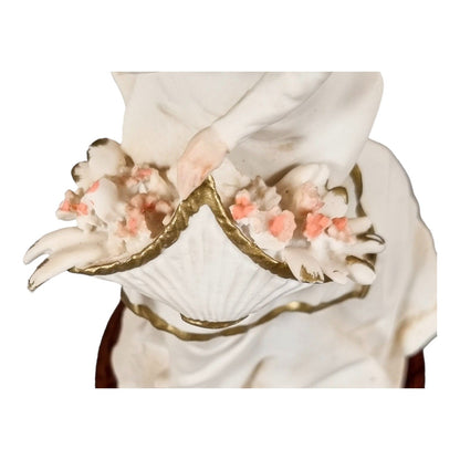 A. Belcari Capodimonte figurine of a young woman holding a flower basket