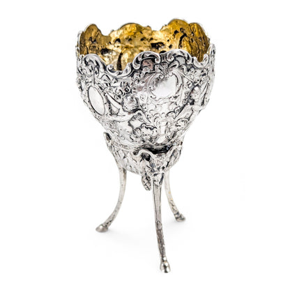 Hanau sterling silver tripod cup with repoussé putti, floral garlands, and ram’s head feet, Baroque Revival, c. 1880s
