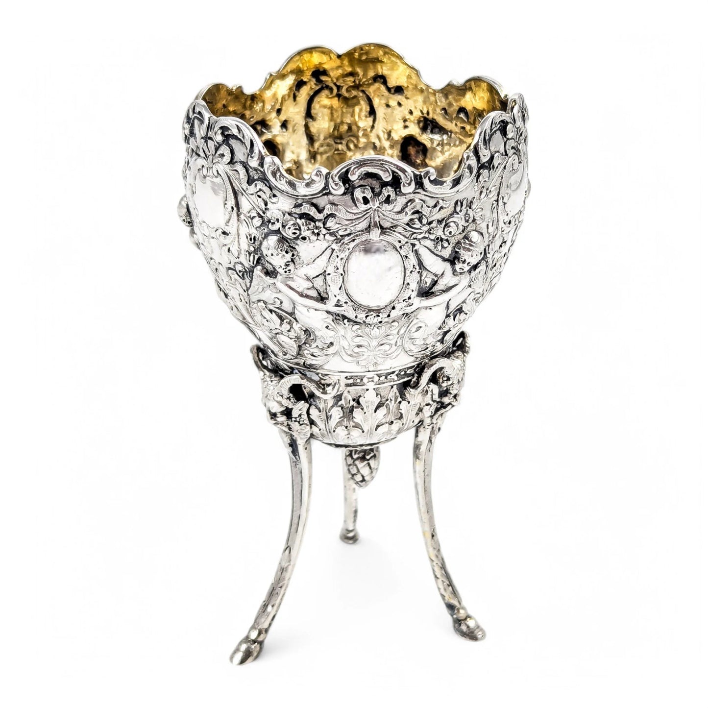Hanau sterling silver tripod cup with repoussé putti, floral garlands, and ram’s head feet, Baroque Revival, c. 1880s