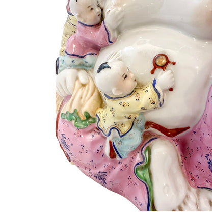 Vintage Chinese porcelain laughing Buddha figurine with children, a symbol of fertility