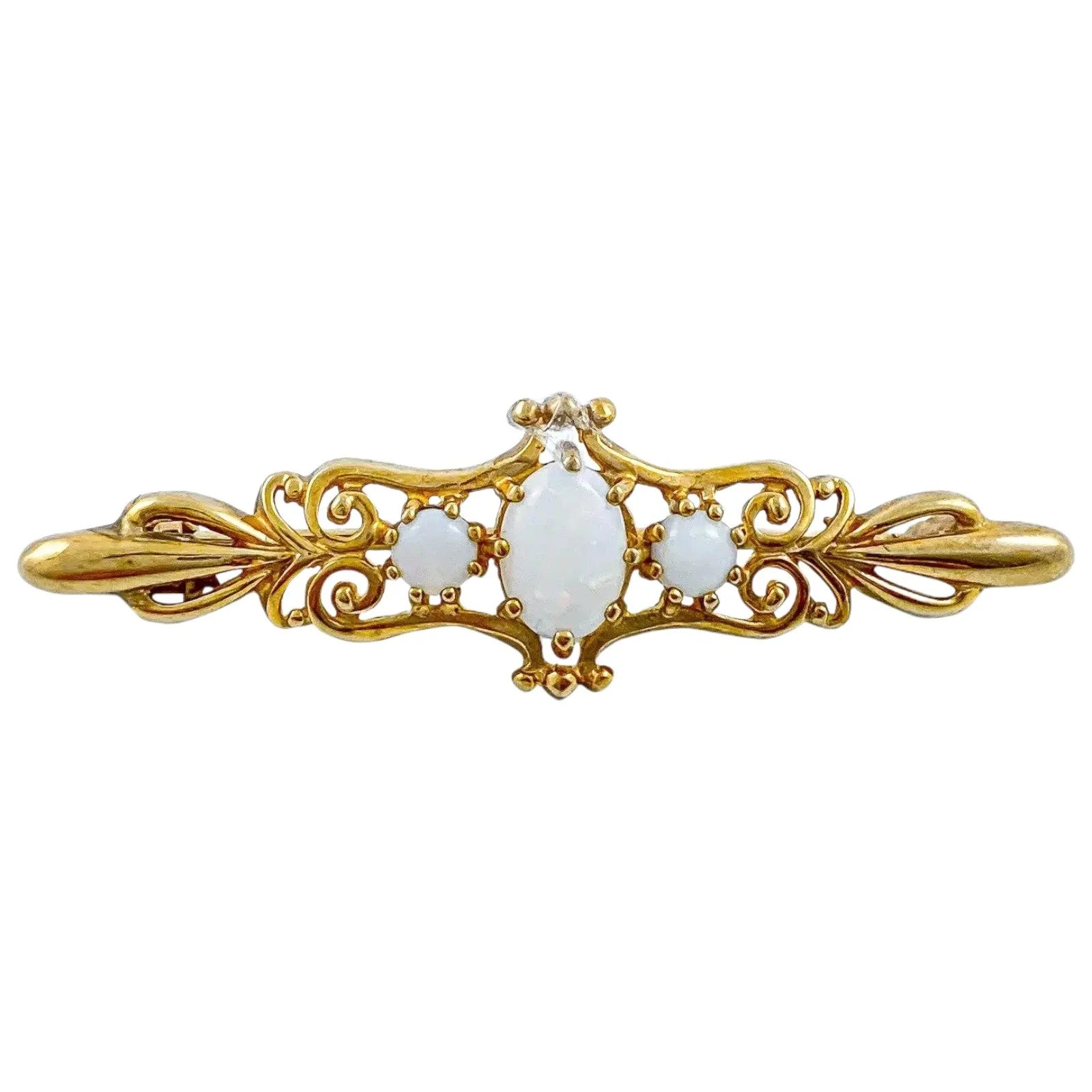 Art Nouveau style yellow gold brooch set with cabochon opals in a scrolling design