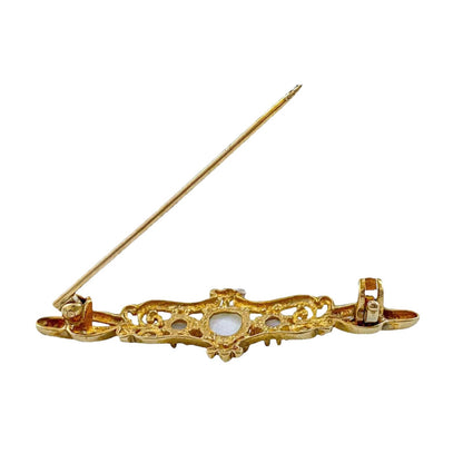 Art Nouveau style yellow gold brooch set with cabochon opals in a scrolling design