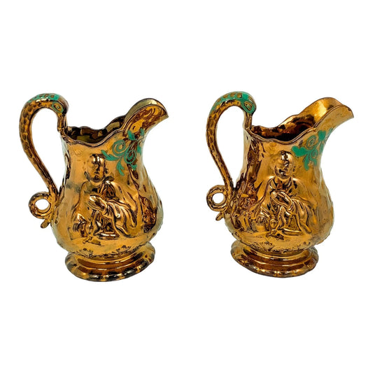 Pair of Victorian pottery copper lustreware moulded jugs / pitchers with religious scenes and snake handles