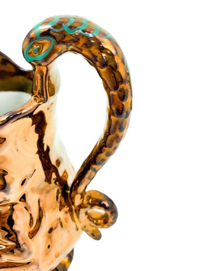 Pair of Victorian pottery copper lustreware moulded jugs / pitchers with religious scenes and snake handles