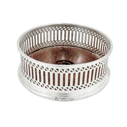 Victorian style mahogany and sterling silver bottle coaster with pierced border