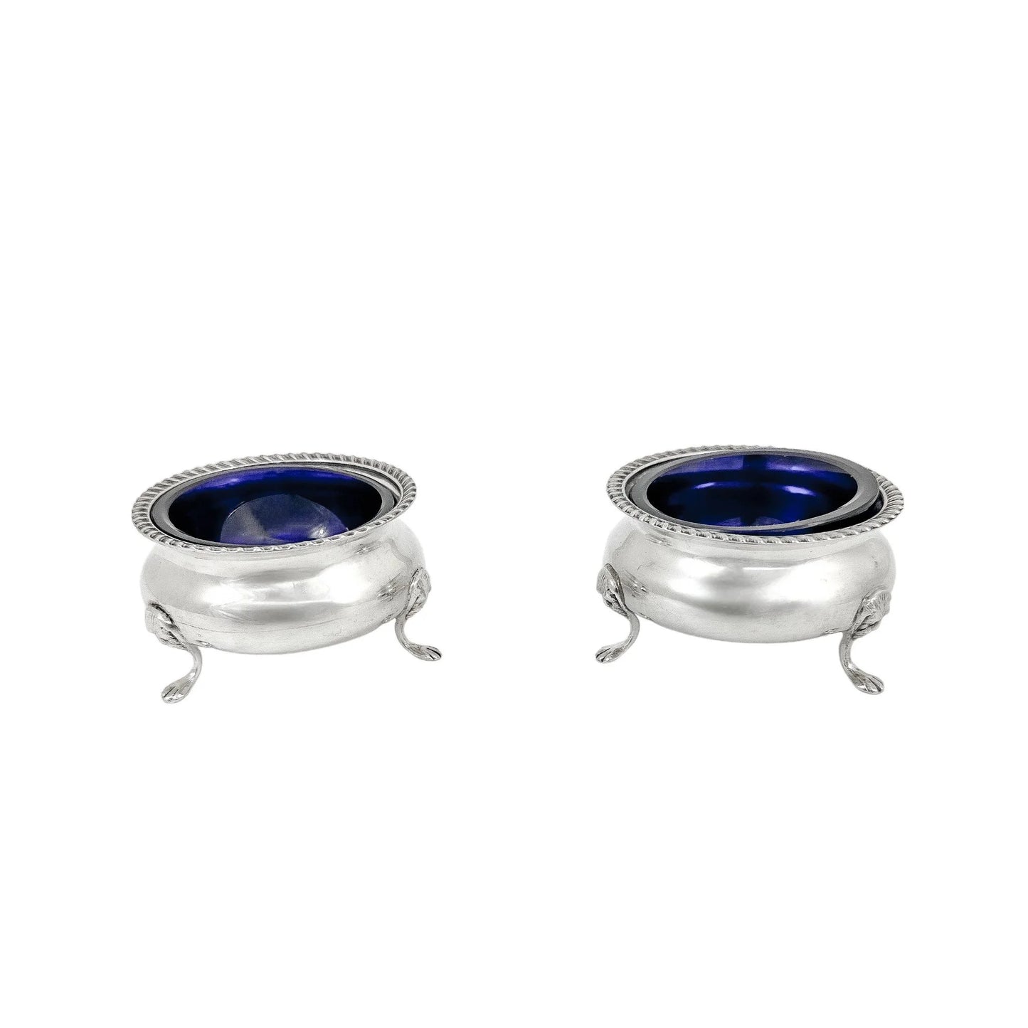 Pair of Edwardian sterling silver cauldron salt cellars with blue glass inserts