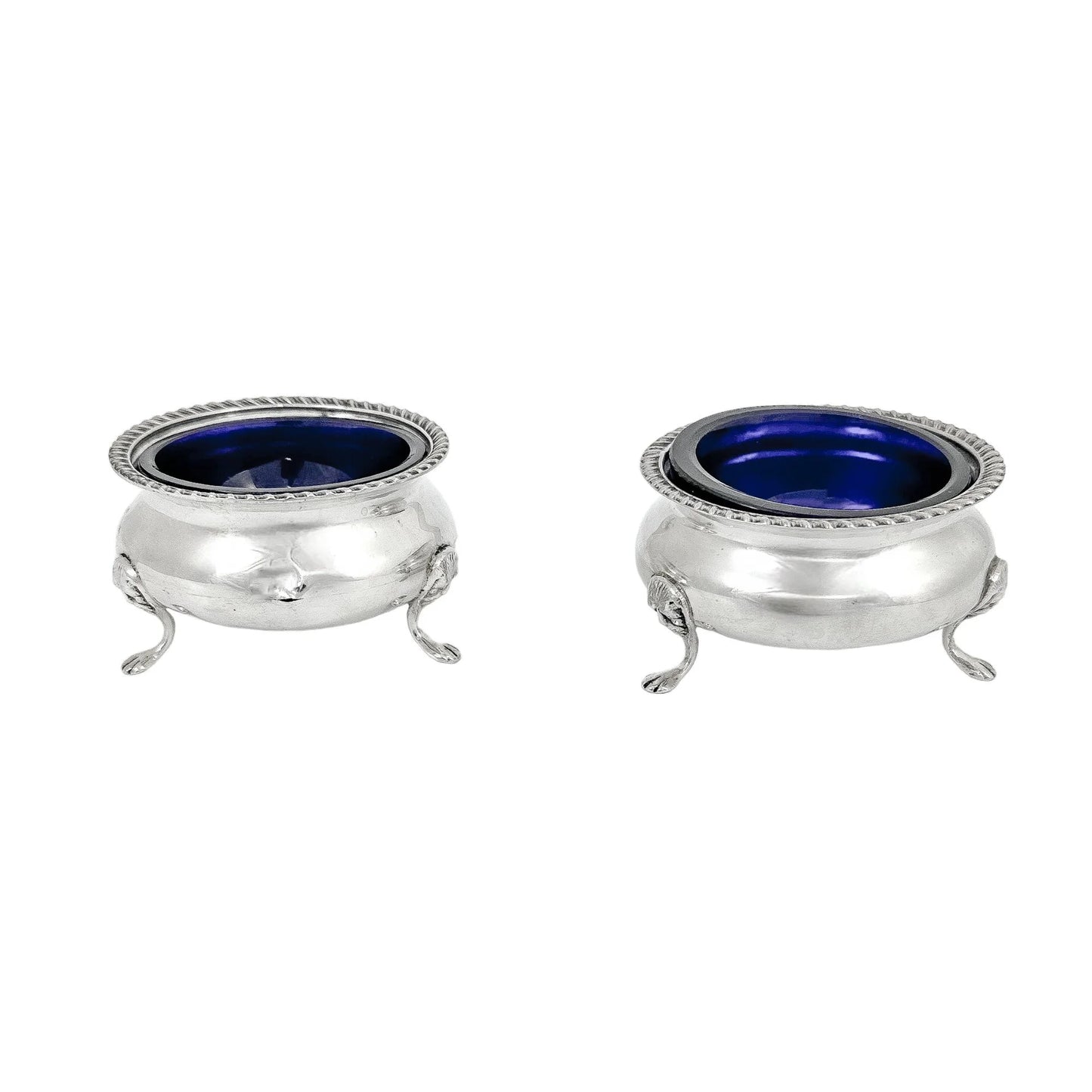Pair of Edwardian sterling silver cauldron salt cellars with blue glass inserts