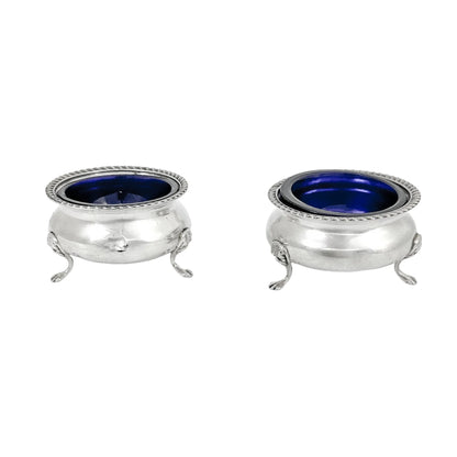 Pair of Edwardian sterling silver cauldron salt cellars with blue glass inserts