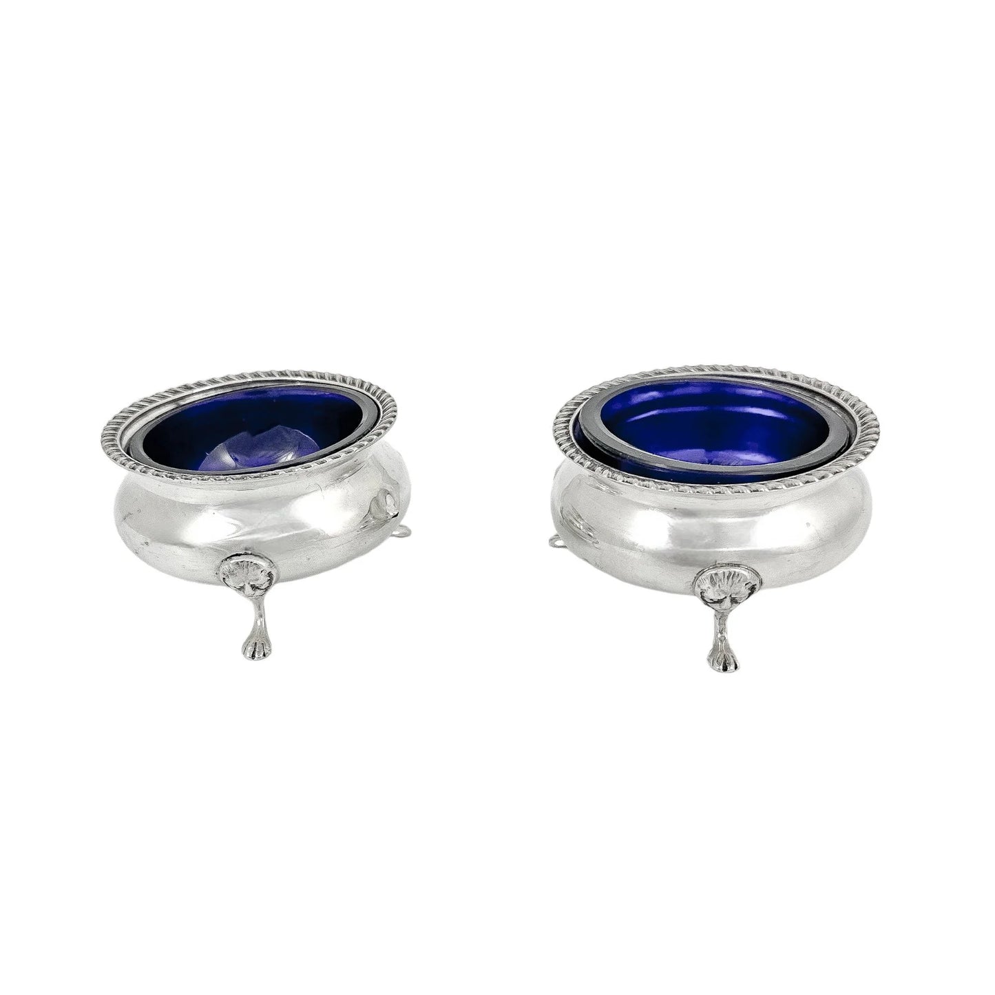 Pair of Edwardian sterling silver cauldron salt cellars with blue glass inserts