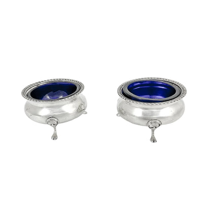 Pair of Edwardian sterling silver cauldron salt cellars with blue glass inserts