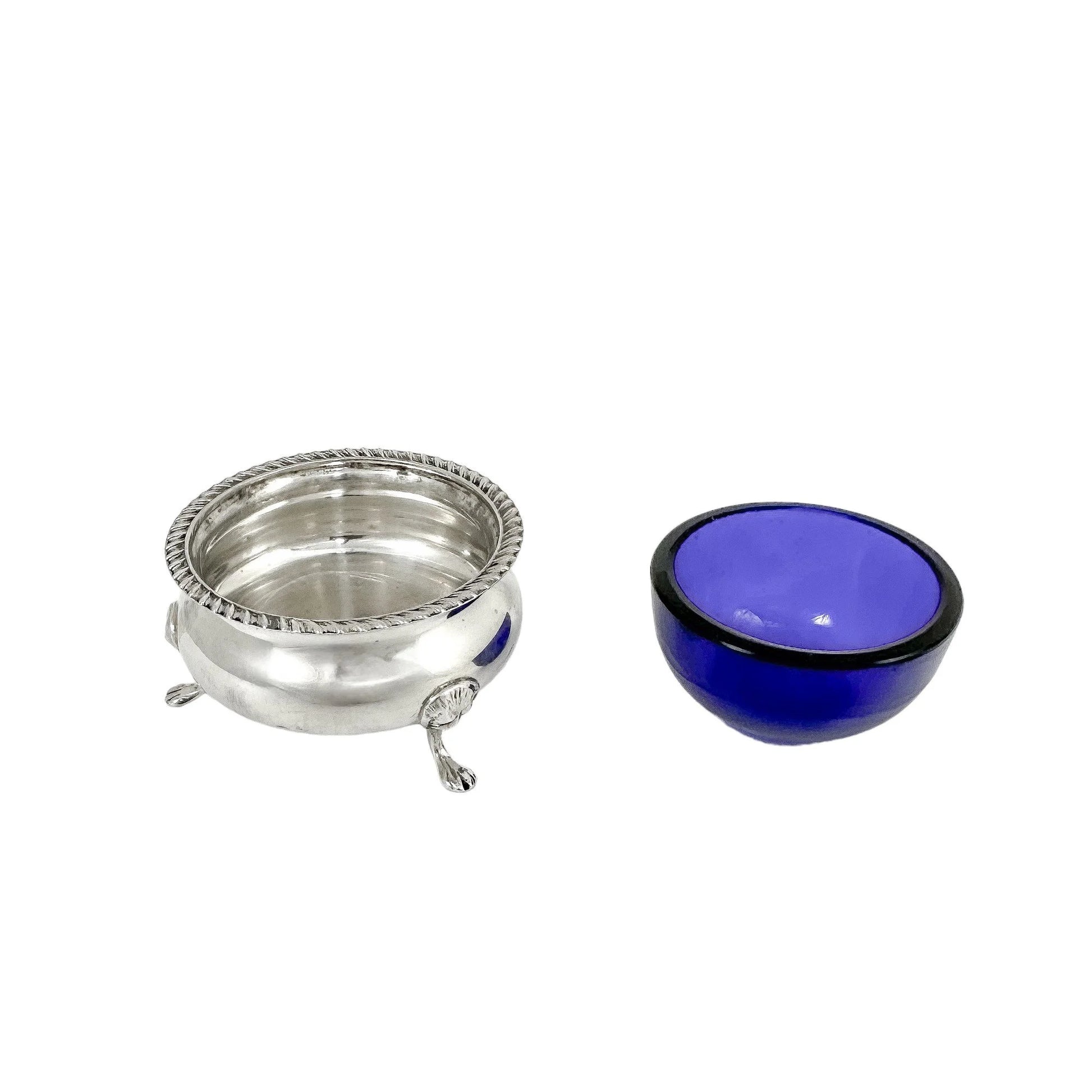 Pair of Edwardian sterling silver cauldron salt cellars with blue glass inserts