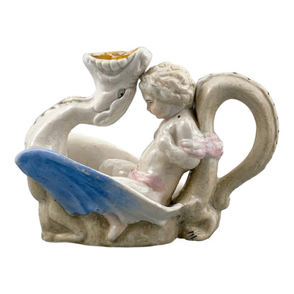 Georgian softpaste porcelain and creamware cherub candle chambersticks, putti on wyvern and leaf