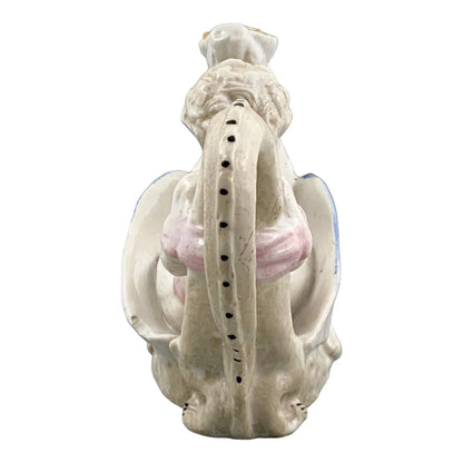 Georgian softpaste porcelain and creamware cherub candle chambersticks, putti on wyvern and leaf